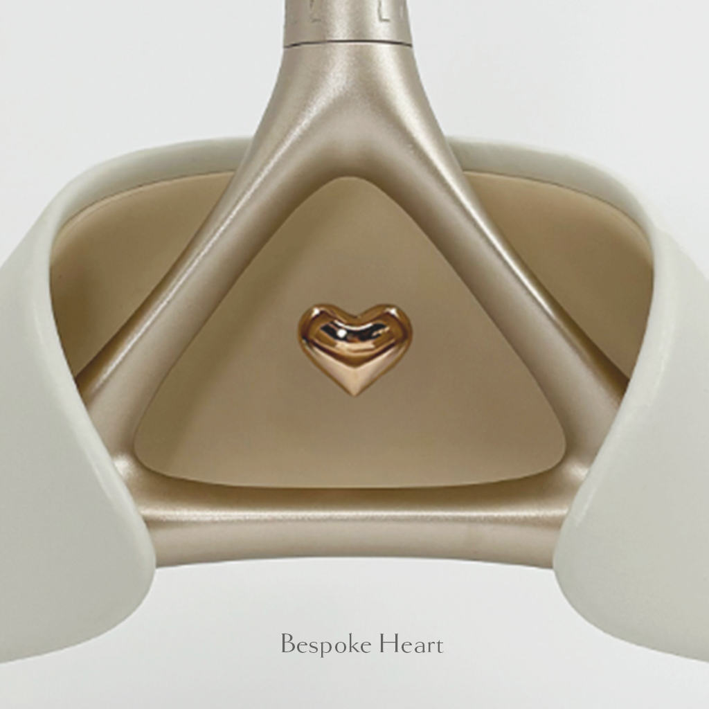 Close-up of Lou Hansell's H series luxury wedding dress hanger in Yellow Gold and Off-White with bespoke heart detailing.