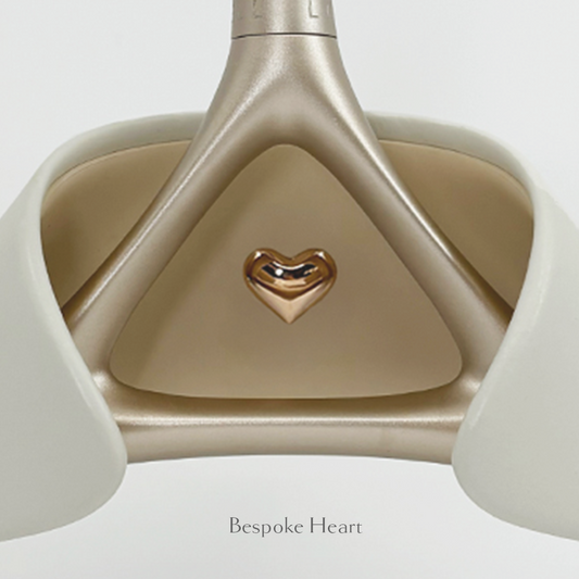 Close-up of Lou Hansell's H series luxury wedding dress hanger in Yellow Gold and Off-White with bespoke heart detailing.