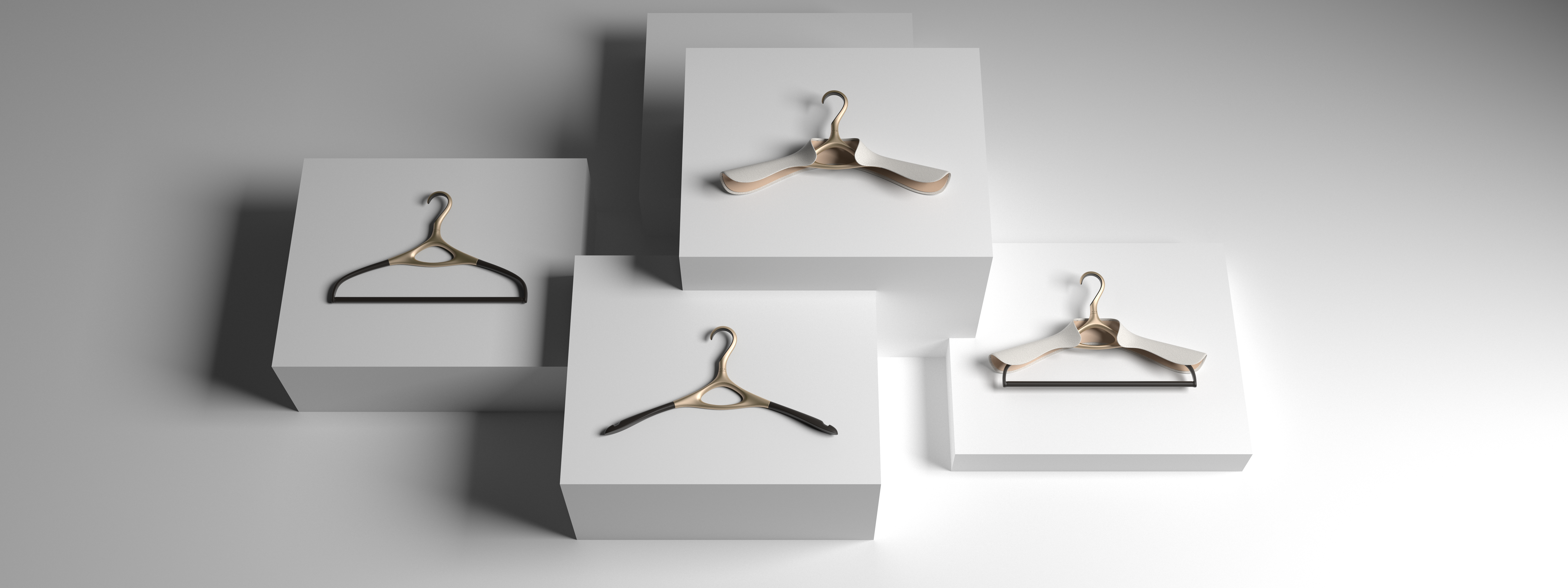Collection of Lou Hansell Yellow Gold luxury garment hangers displayed on white blocks, showcasing elegant design and craftsmanship available worldwide.