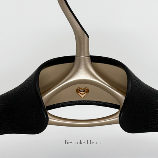 Close-up of Lou Hansell's L series luxury bridal hanger with a trouser bar in Yellow Gold and Black with bespoke heart detailing.