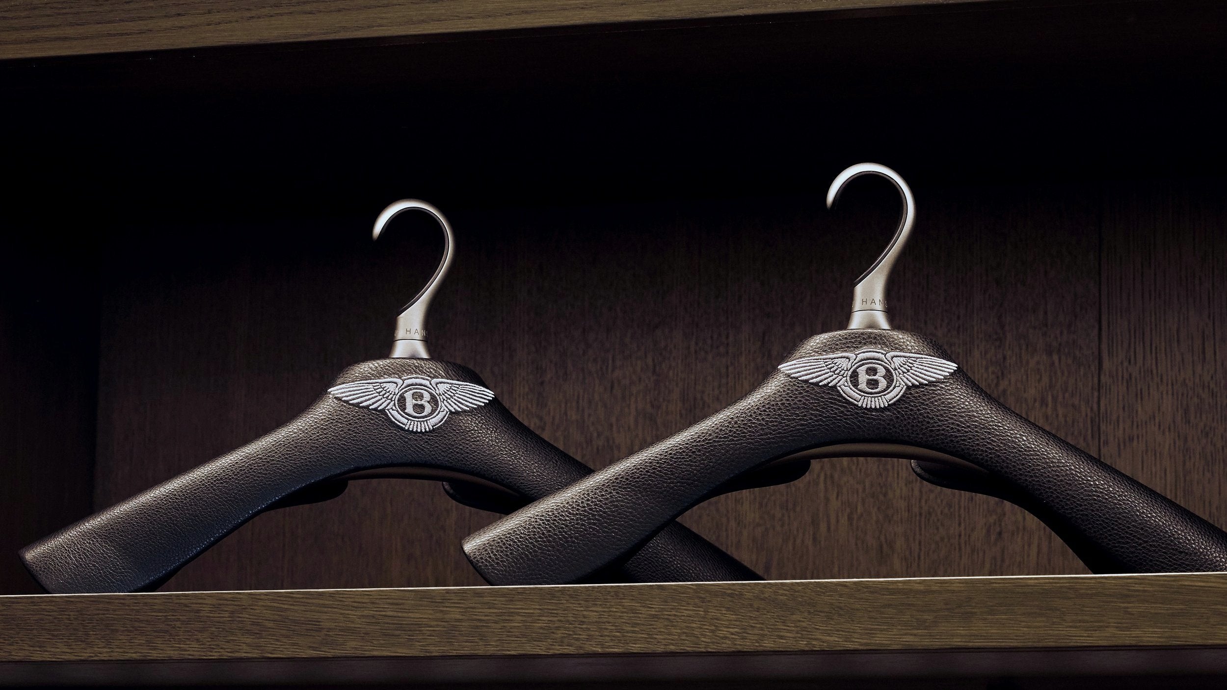 two bespoke hangers wrapped in leather