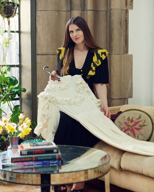 Laura McLaws Helms, Fashion and Cultural Historian, with a dress on a Lou Hansell hanger