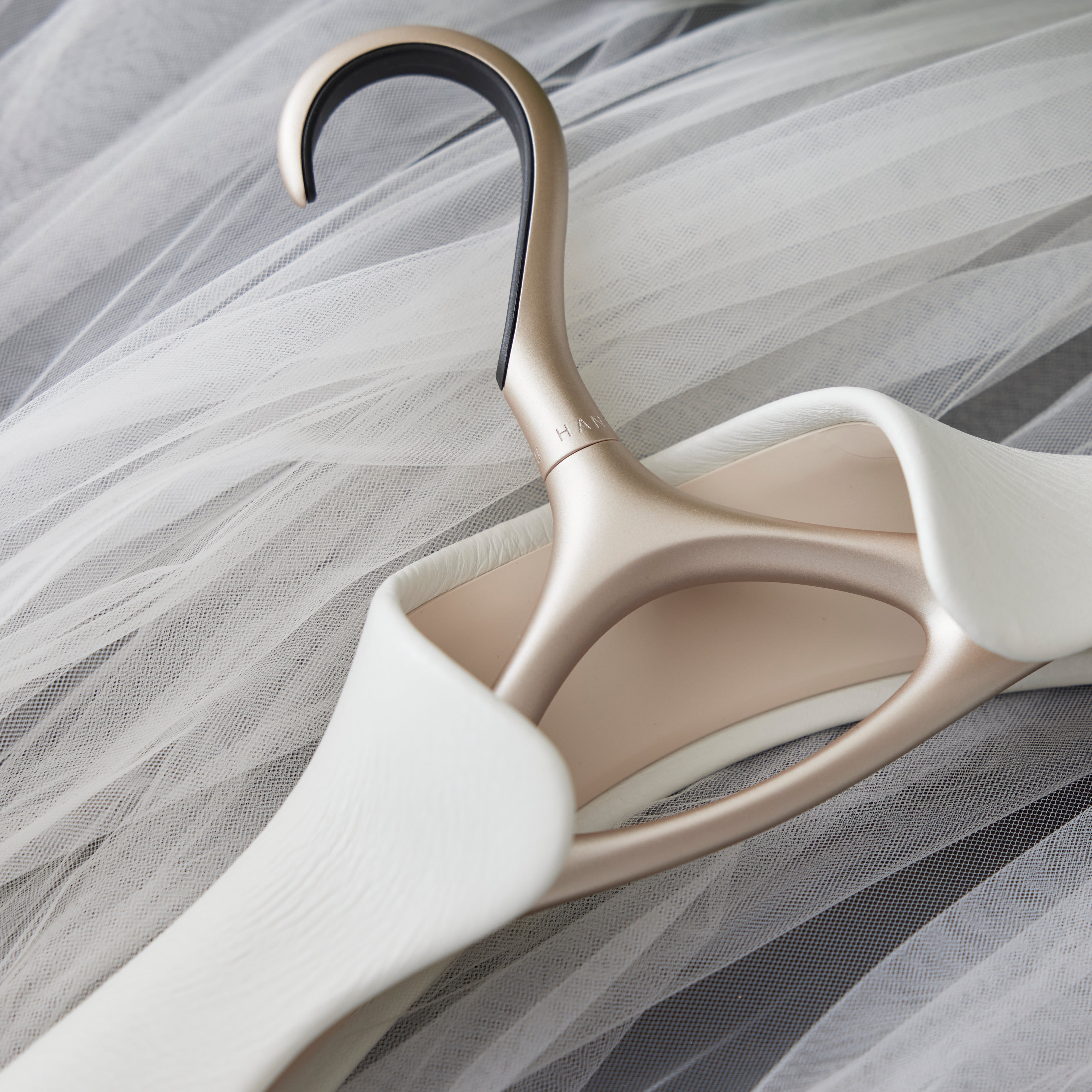 Metal hanger with white leather