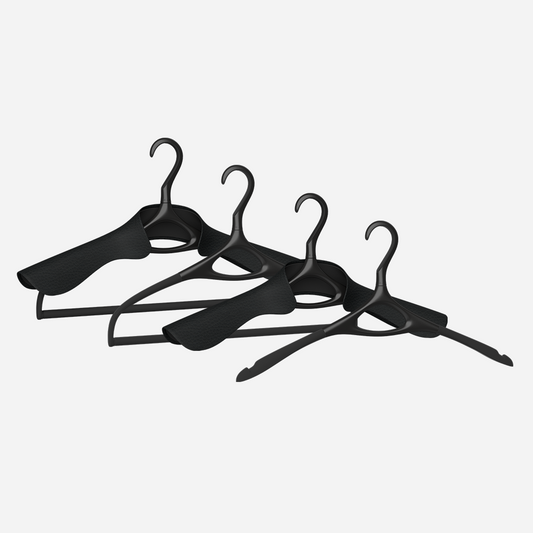 A set of four Lou Hansell L Series luxury hangers in matte black, including a base hanger, a jacket hanger, a trousers hanger, and a jacket and trousers hanger, 