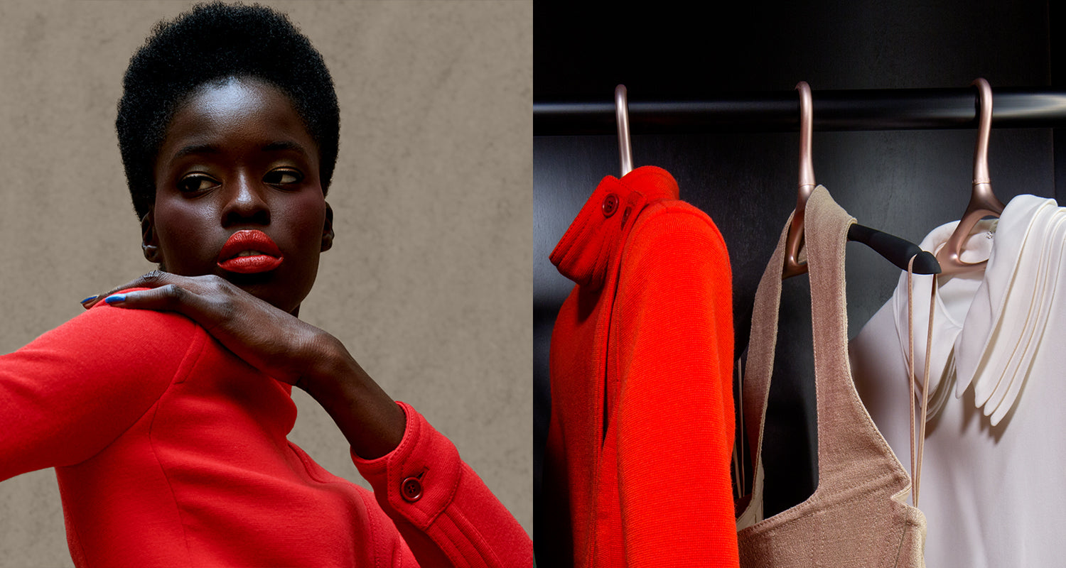 Woman in red dress next to a closet with dresses on hangers